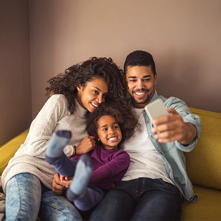Happy Smiling Family On Couch